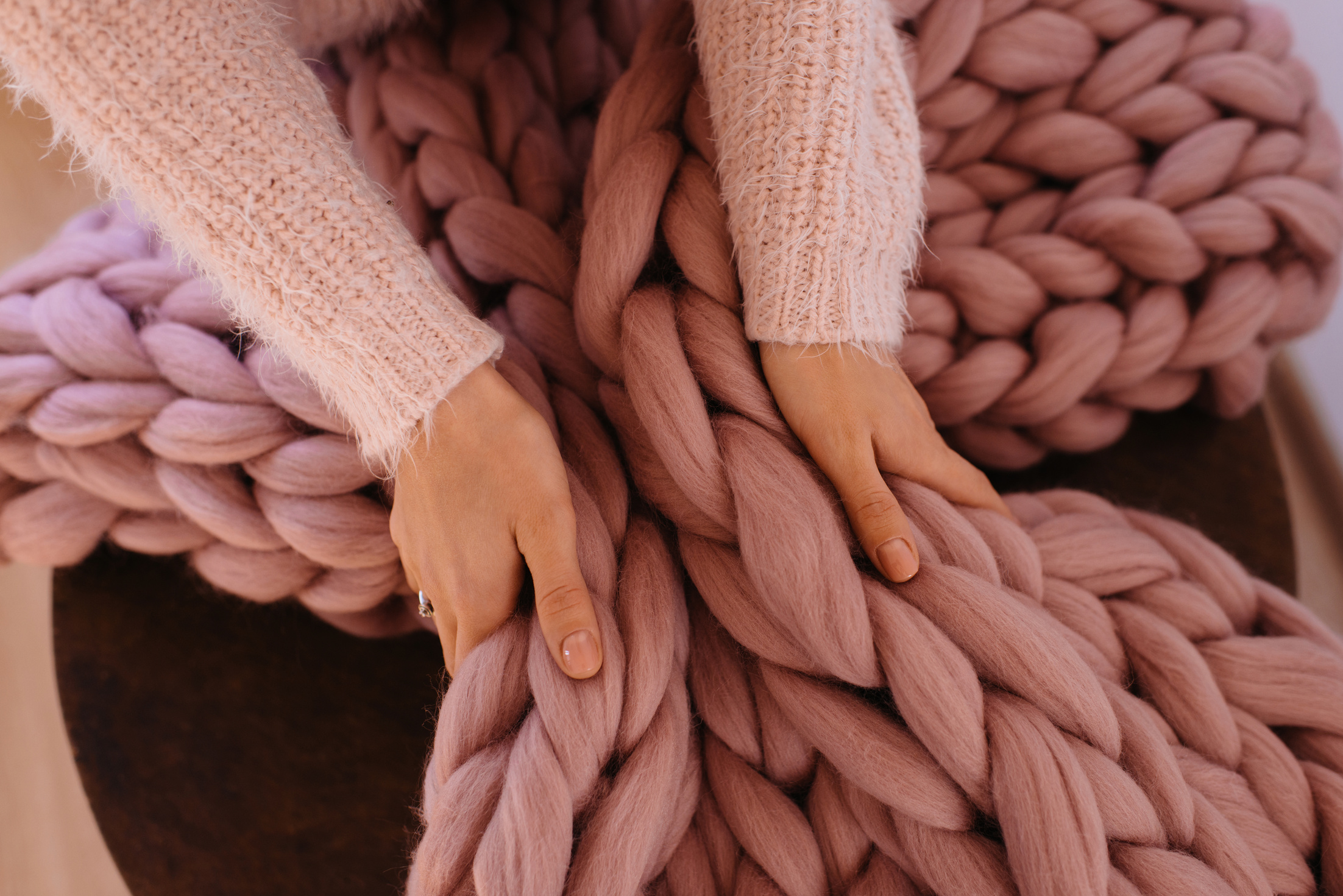 Girl hands holding warm pink blanket